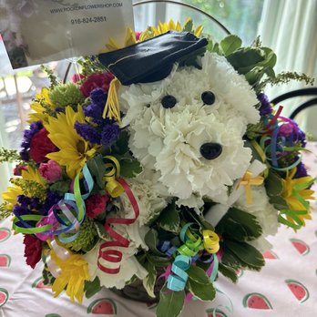 Rocklin Flower Shop - Graduation ‍ basket of flowers  they dog has a graduation cap and a diploma - Florists Near Me - Rocklin, California