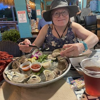 Nokomo's Sunset Hut - My wife, enjoying some oysters on the half shell. - Seafood Near Me - Nokomis, Florida Nokomo's Sunset Hut - My wife, enjoying some oysters on the half shell. - Seafood Near Me - Nokomis, Florida