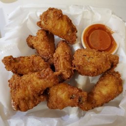 Fried wings with a side of buffalo sauce Fried wings with a side of buffalo sauce