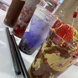 [Left to Right] Dubai Pistachio "cracking choco cup" Strawberry Cookies and Cream Smoothie Taro Crème brûlée with boba Dubai strawberry cup