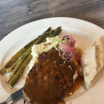 The Kitchen - Pork chop, mashed potatoes, and asparagus with a piece of sourdough bread - Burgers Near Me - The Woodlands, Texas The Kitchen - Pork chop, mashed potatoes, and asparagus with a piece of sourdough bread - Burgers Near Me - The Woodlands, Texas