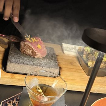 insideOUT - Stone filet mignon. The server explains how to cook it and it's really easy. 10/10 - Lounges Near Me - San Diego, California
