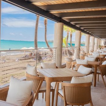 Ocean Lab Taproom - A beachfront dining area with open-air seating, ocean views, and a relaxed coastal atmosphere. - Breweries Near Me - Carolina, Puerto Rico Ocean Lab Taproom - A beachfront dining area with open-air seating, ocean views, and a relaxed coastal atmosphere. - Breweries Near Me - Carolina, Puerto Rico