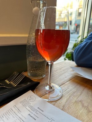 Photo of The Blackbird Restaurant - Asheville, NC, US. a glass of wine on a table