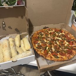 Pizza with pepperoni, sausage and jalapeños. Along with warm Breadsticks and Mimi's Pizza Sauce