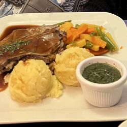 The Coachman's Townhouse - Roasted Lamb, mint relish, season veggies, mashed potatoes and stuffing.