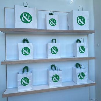 Crisp & Green - a display of green and white shopping bags - Salad Near Me - Apple Valley, Minnesota