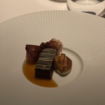 Addison - Dessert chocolate pastry with hazelnut and caramel sauce . Can't remember what else they said - New American Near Me - San Diego, California