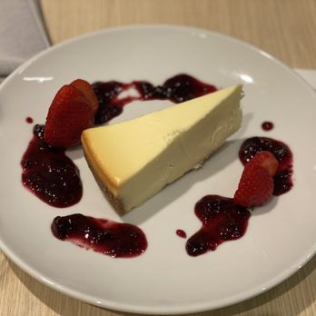 47 North Bar + Bistro - a piece of cheesecake with berry sauce - New American Near Me - Bellevue, Washington 47 North Bar + Bistro - a piece of cheesecake with berry sauce - New American Near Me - Bellevue, Washington