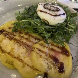 Heirloom tomatoes, Burrata cheese & Arugula drizzled with balsamic sauce Heirloom tomatoes, Burrata cheese & Arugula drizzled with balsamic sauce