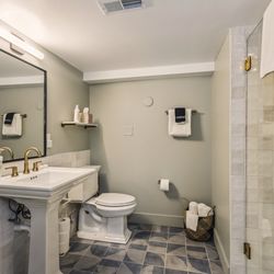 The Neighborhood Hotel New Buffalo - The Garden Suite (#10) at The Neighborhood Hotel at 18 West Merchant Street includes a kitchen and dining table.
