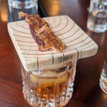 Sage Speakeasy & Lounge - Candied bacon atop the Bacon Washed Smoked Old Fashion - Speakeasies Near Me - Loveland, Colorado