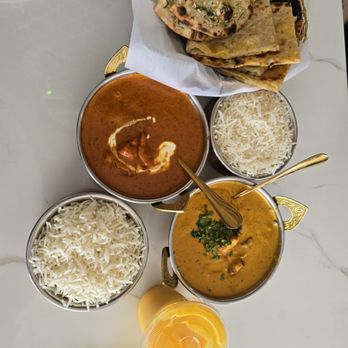 The Indian Deck - From Top to Bottom: Garlic and Cheese Naan, Butter Chicken and Jasmine rice, Chicken Tikka Masala and Jasmine rice, Mango Lassi - Indian Near Me - Houston, Texas