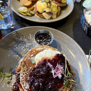 Eggspectation - Complexe Desjardins - Burnt orange and cherry compote ricotta pancakes, and smoked meat eggs benedict - Breakfast & Brunch Near Me - Montreal, Quebec