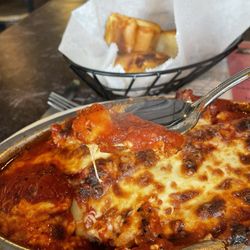 Angelo's Italian Restaurant - Manicotti with ricotta and Italian sausage and bread to accompany the meal