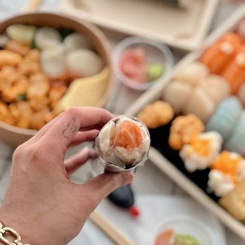 Oroshi Fish Co - a person holding a piece of sushi - Japanese Near Me - Toronto, Ontario Oroshi Fish Co - a person holding a piece of sushi - Japanese Near Me - Toronto, Ontario