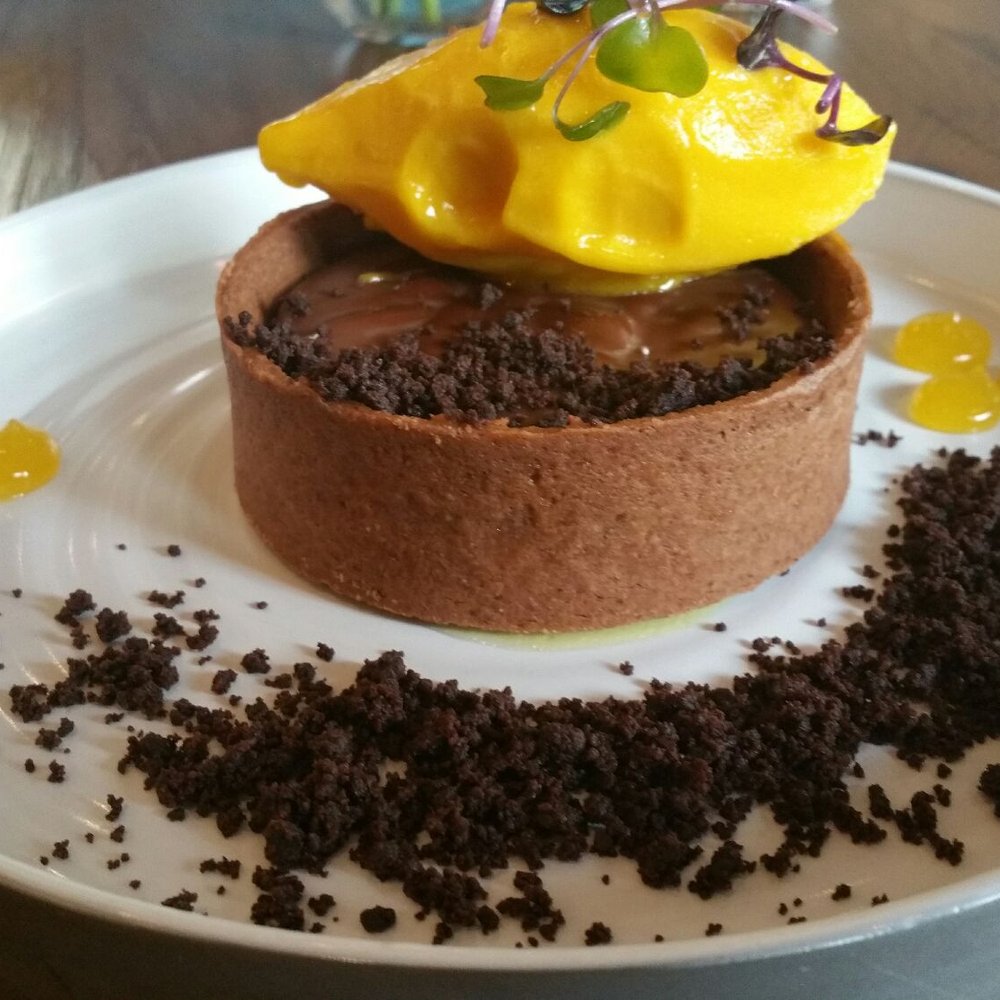 Vasili's Kitchen - Dessert - Chocolate Tart (bitter chocolate ganache, mango sorbet, passion fruit gel) - great for folks that love chocolate. - Mediterranean Near Me - Gaithersburg, Maryland Vasili's Kitchen - Dessert - Chocolate Tart (bitter chocolate ganache, mango sorbet, passion fruit gel) - great for folks that love chocolate. - Mediterranean Near Me - Gaithersburg, Maryland