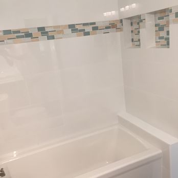 Prestige Installations - a bathtub and toilet in a bathroom - Flooring Near Me