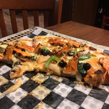 Tall Tales Tavern - a half eaten pizza on a checkered tablecloth - New American Near Me - Queensbury, New York Tall Tales Tavern - a half eaten pizza on a checkered tablecloth - New American Near Me - Queensbury, New York