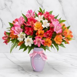 Bright and cheerful arrangement featuring a vibrant mix of pink, red, orange, and white alstroemerias.