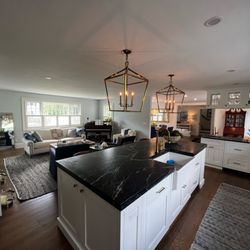 Love Creek Construction - Gorgeous lighting and hardwood floors accent this updated kitchen.