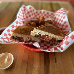 Gourmeltz - Veggie Burger Melt w/ sweet potato tater tots.