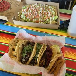 Street Tacos - Shrimp taco, Barbacoa taco, steak taco and cochinita taco with pickled red onions.