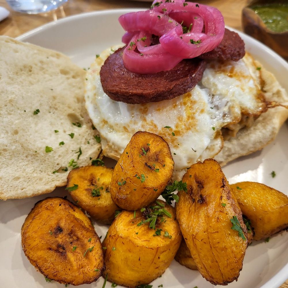 Libélula Bakery and Kitchen - Dr breakfast sandwich (egg cheese sausage on a Portuguese roll) with side of maduros - Dominican Near Me - Montclair, New Jersey Libélula Bakery and Kitchen - Dr breakfast sandwich (egg cheese sausage on a Portuguese roll) with side of maduros - Dominican Near Me - Montclair, New Jersey