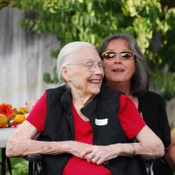 Almond Blossom Assisted Living - Resident and family member enjoying each others company in the backyard.