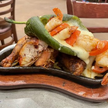 Pericos Mexican Cuisine - Pollo asado "Fuego Style": Jack cheese-stuffed poblano with Gulf shrimp and tomatoes on top - Tex-Mex Near Me - San Antonio, Texas Pericos Mexican Cuisine - Pollo asado "Fuego Style": Jack cheese-stuffed poblano with Gulf shrimp and tomatoes on top - Tex-Mex Near Me - San Antonio, Texas