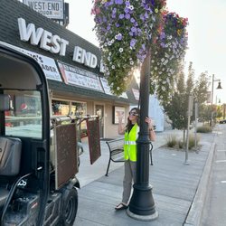 West End Liquor & Fine Cigars - Cate, owner of West End Liquor is watering the flower baskets.....