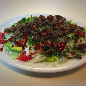 Juli's Restaurant - $12.30 for a house salad topped with 3 tacos worth of beef, onion and cilantro. - Mexican Near Me - Clearwater, Florida
