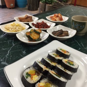 Kum's Cafe - From back to front; Kim chi (mild) cabbage, potato, sun-dried tomato, bean sprouts, cucumber. Kim Bop appetizer roll in front. - Korean Near Me - Louisville, Kentucky