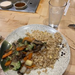 Grilled steak, fried rice, and grilled vegetables