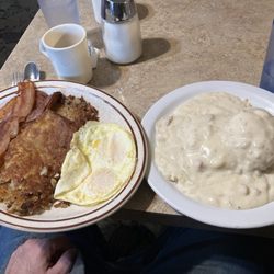 Plainsman Restaurant - This is one order of biscuits and gravy with hash browns, two eggs, 4 strips of bacon.