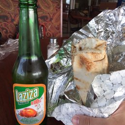A chicken shawarma with a malted peach beverage on the side. These made for a great combo! A chicken shawarma with a malted peach beverage on the side. These made for a great combo!