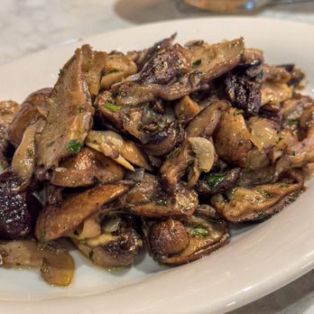 Andiamo - a plate of mushrooms on a table - Bars Near Me - Mystic, Connecticut