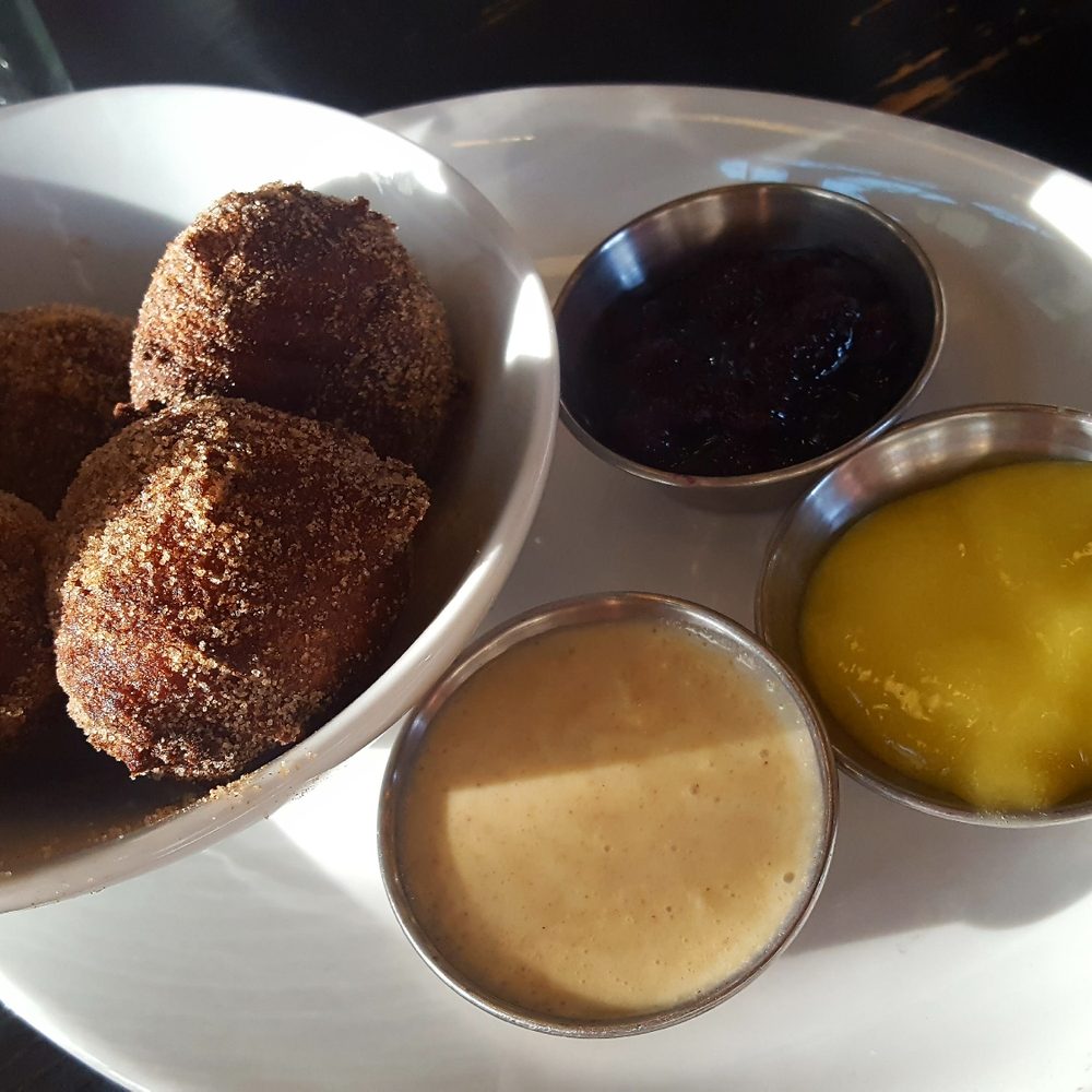 Merchants Pub & Plate - Donuts with berry jam, lemon curd, and cinnamon sauce - New American Near Me - Lawrence, Kansas