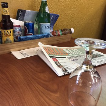 Indian Bistro - A lot going on on the tables with the addition of newspapers, magazines and a paper menu. - Indian Near Me - Clearwater, Florida