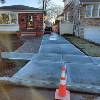 Loffreno Landscape Contracting - an orange traffic cone on a sidewalk - Masonry/Concrete Near Me - Staten Island, New York Loffreno Landscape Contracting - an orange traffic cone on a sidewalk - Masonry/Concrete Near Me - Staten Island, New York