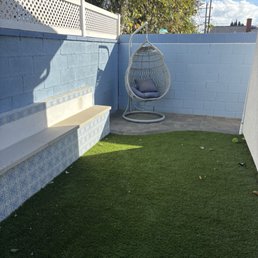 Turf, retaining wall bench and pavers and painted wall. Turf, retaining wall bench and pavers and painted wall.