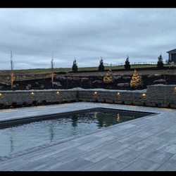 Sutton Outdoor, LLC - Pool decking, paver patio, retaining wall, lighting, and all landscaping completed by Sutton Outdoor