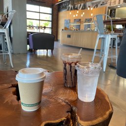two cups of iced coffee on a wooden table two cups of iced coffee on a wooden table