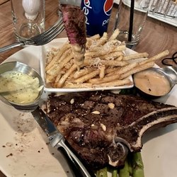 Medium Rare Carnivore Club - 14 oz ripeye with truffle fries, delicious sauces on green asparagus.