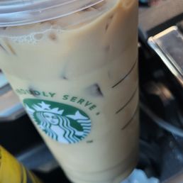 a hand holding a cup of coffee