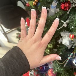 Short french tip nail with silver line on the ring finger Short french tip nail with silver line on the ring finger