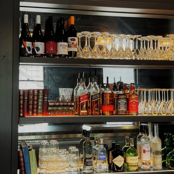 The Norfolk Pub - a shelf full of liquor bottles and glasses - American Near Me - Norfolk, Connecticut The Norfolk Pub - a shelf full of liquor bottles and glasses - American Near Me - Norfolk, Connecticut