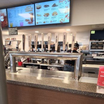 Dunkin' -  a man behind the counter at a dunkin donuts restaurant - Donuts Near Me - Garden City Park, New York