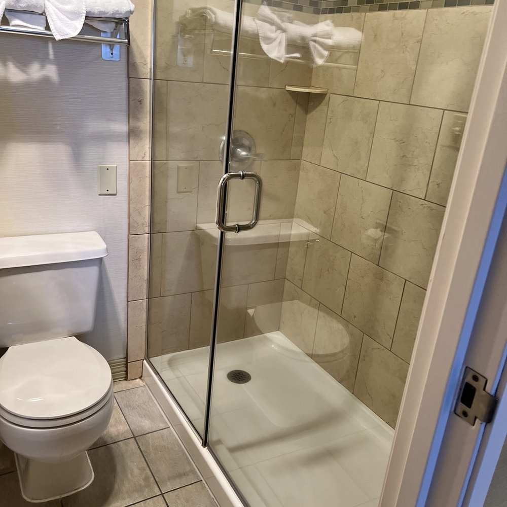 The bathroom with an all glass shower door.