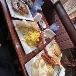 American Table Family Restaurant - (2) 3 Eggs, 2 Meat. Both Bacon, One Sunny Side Up, One Scrambled with White Toast. An order of regular french toast and pancakes.